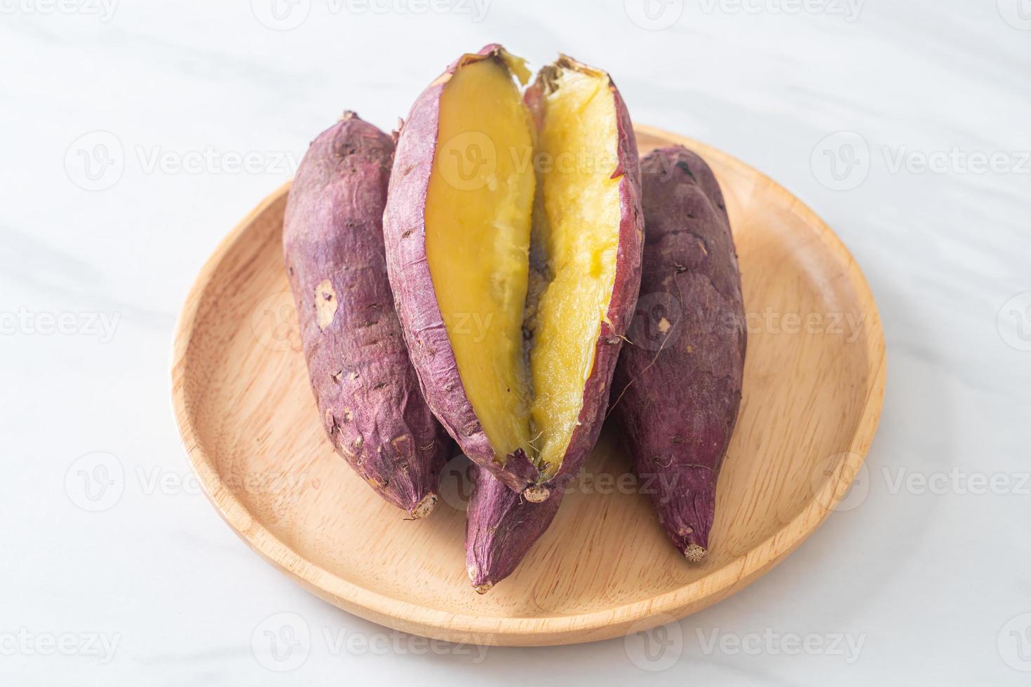 Grilled or baked Japanese sweet potatoes on wood plate photo