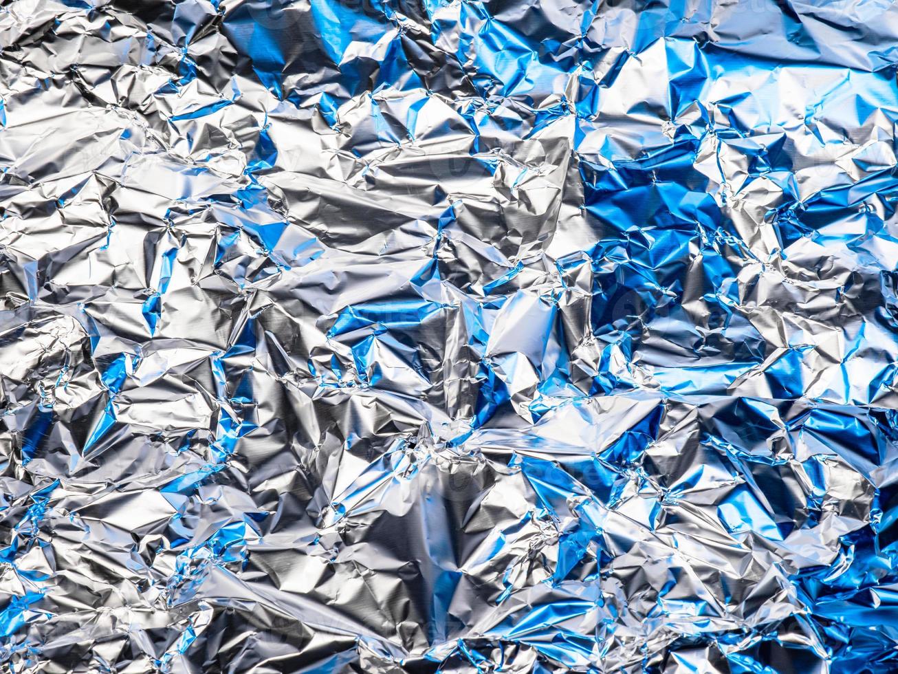 https://static.vecteezy.com/system/resources/previews/016/788/565/non_2x/the-surface-of-the-foil-is-wrinkled-there-is-a-blue-light-reflecting-light-and-shadow-and-saw-silver-photo.jpg