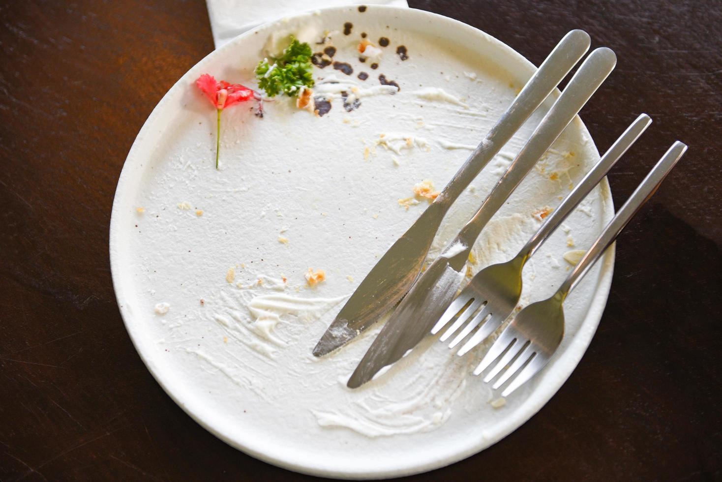 dirty dishes with cake and knife fork dirty plate and empty dishes photo