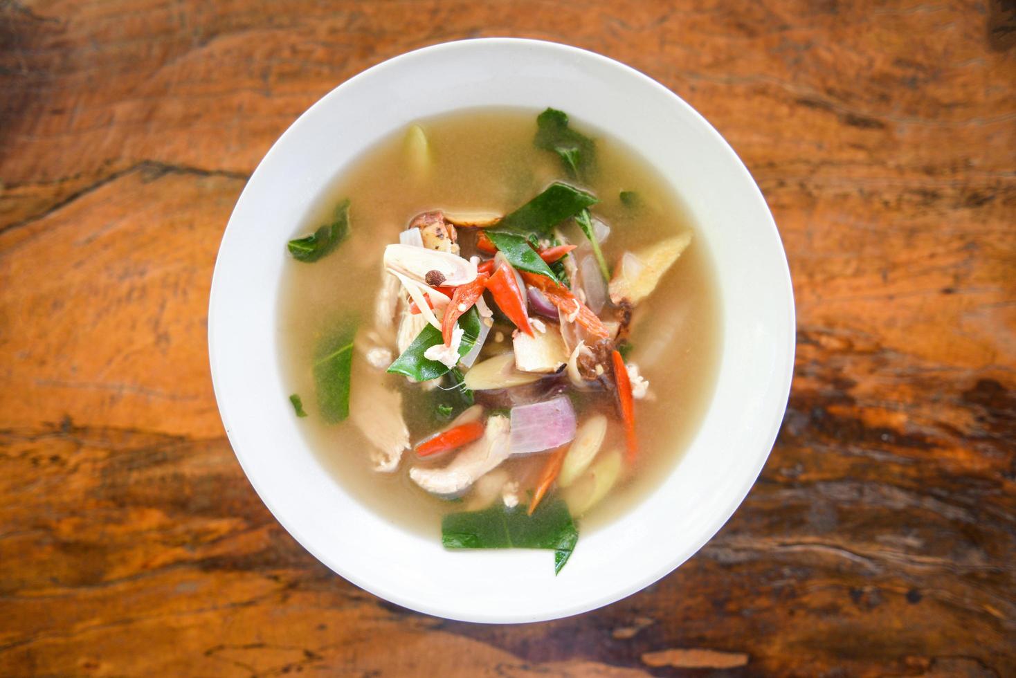 Spicy Chicken Soup - Chicken Tom Yum Spicy Thai food on white bowl photo