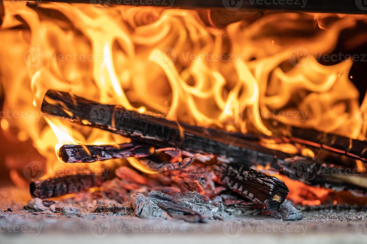 Burning firewood in the fireplace close up. Inside a blazing wood photo