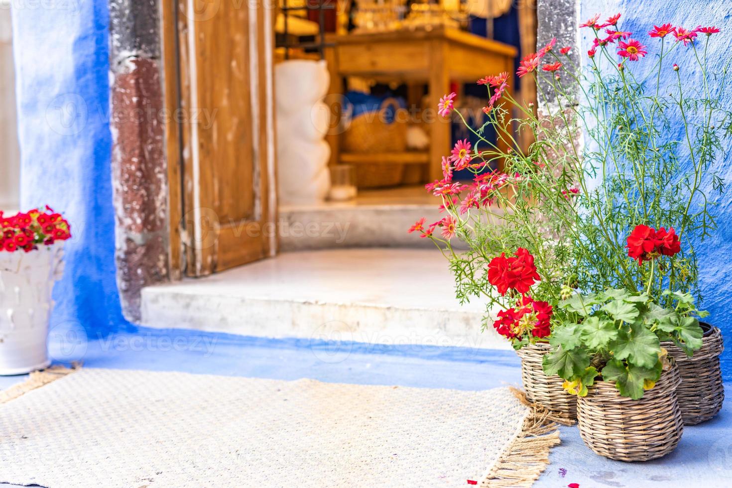 Traditional greek house as shop, Cycledic architecture, Santorini, Greece. Flowers and old entrance, vintage design, summer relaxing mood photo