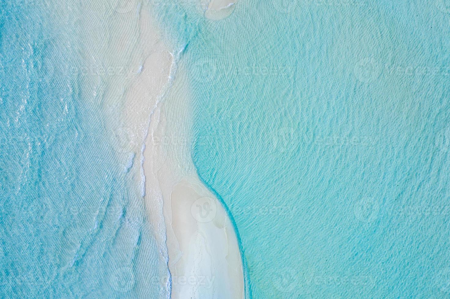 Beautiful sand bank, aerial view of sea surface. Top view of transparent turquoise ocean water surface, ripples and soft waves. Beautiful nature environment. Sea ocean water concept, sunny weather photo
