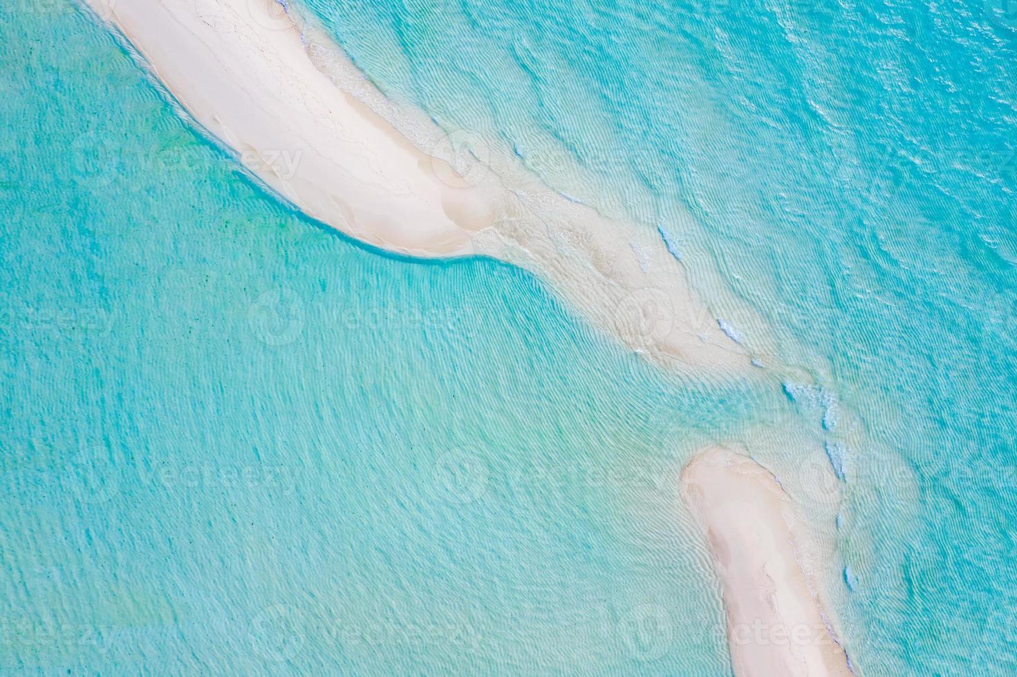 Beautiful sand bank, aerial view of sea surface. Top view of transparent turquoise ocean water surface, ripples and soft waves. Beautiful nature environment. Sea ocean water concept, sunny weather photo