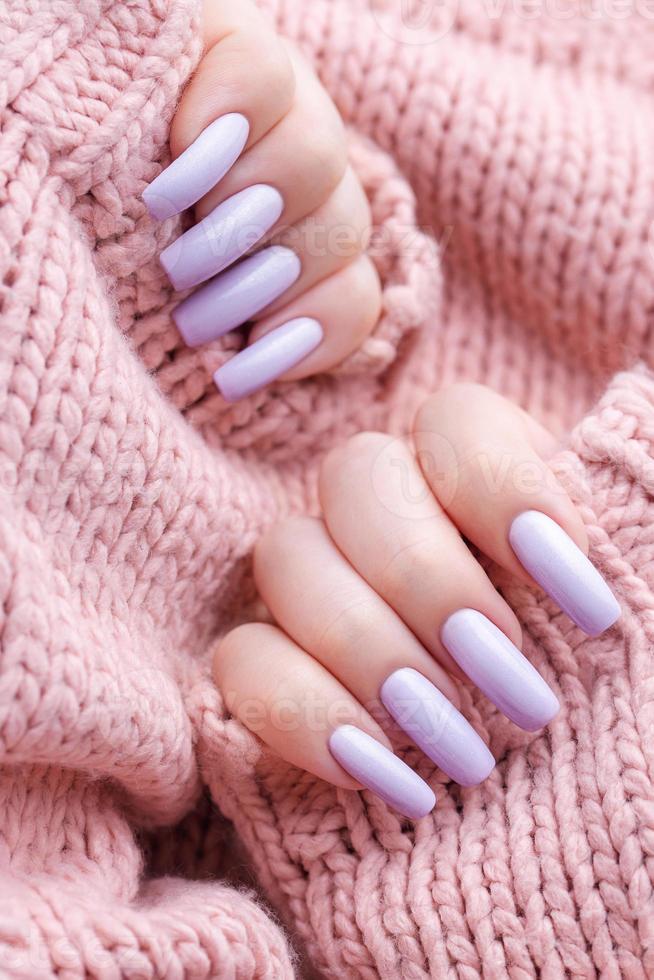 Girl's hands with a soft purple manicure. photo