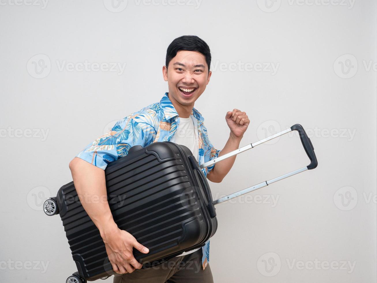 Cheerful man beach shirt hold luggage feels happy with holiday isolated photo