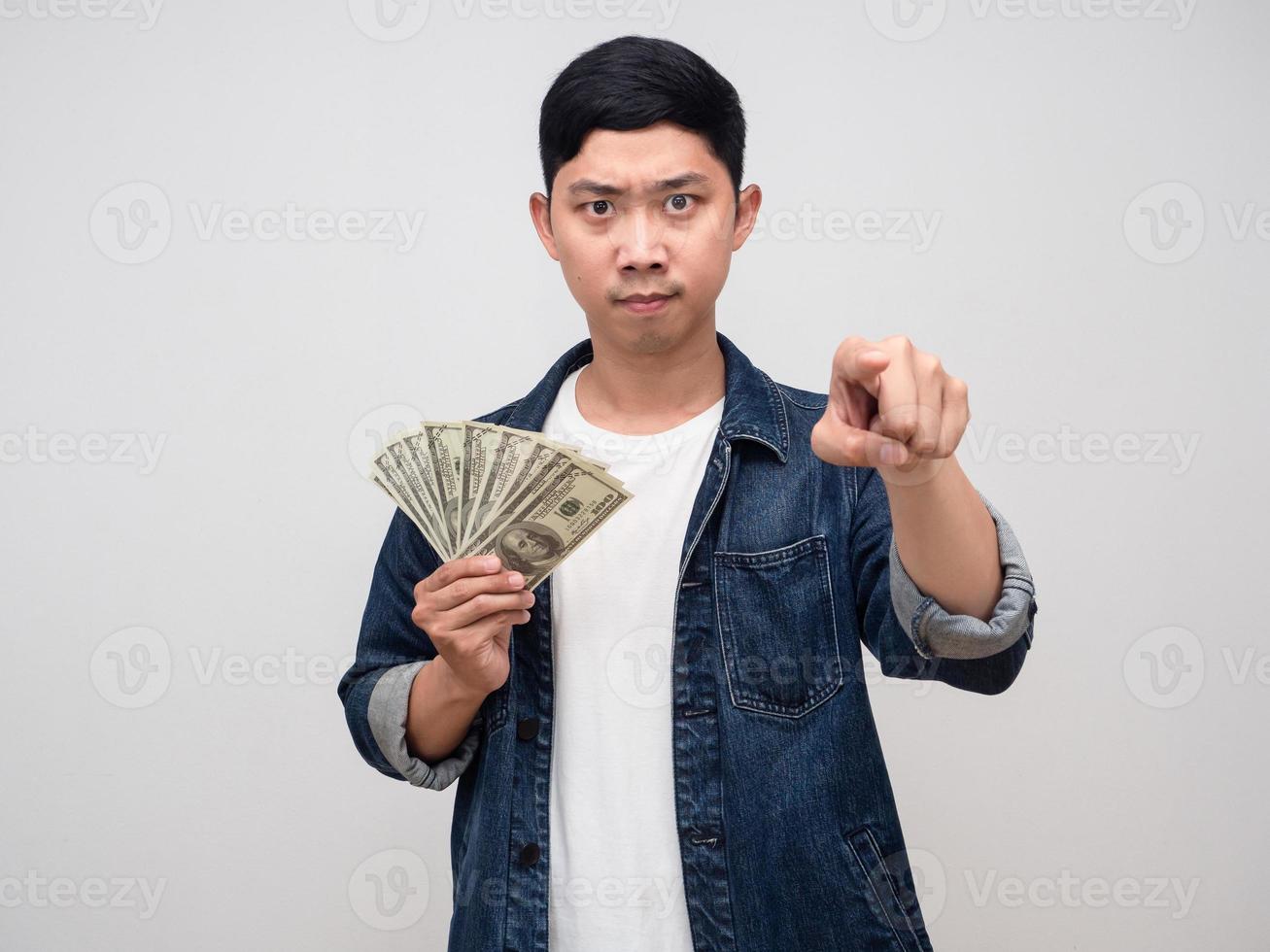 Man jeans shirt hold money serious emotion point finger at you,Debt concept photo