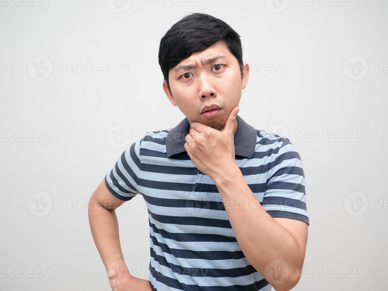 Young man striped shirt gesture confused looking at camera photo