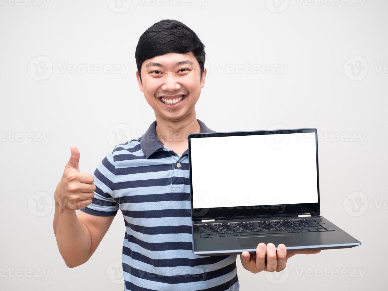 Portrait cheerful man striped shirt thumb up holding laptop white screen happy smile photo