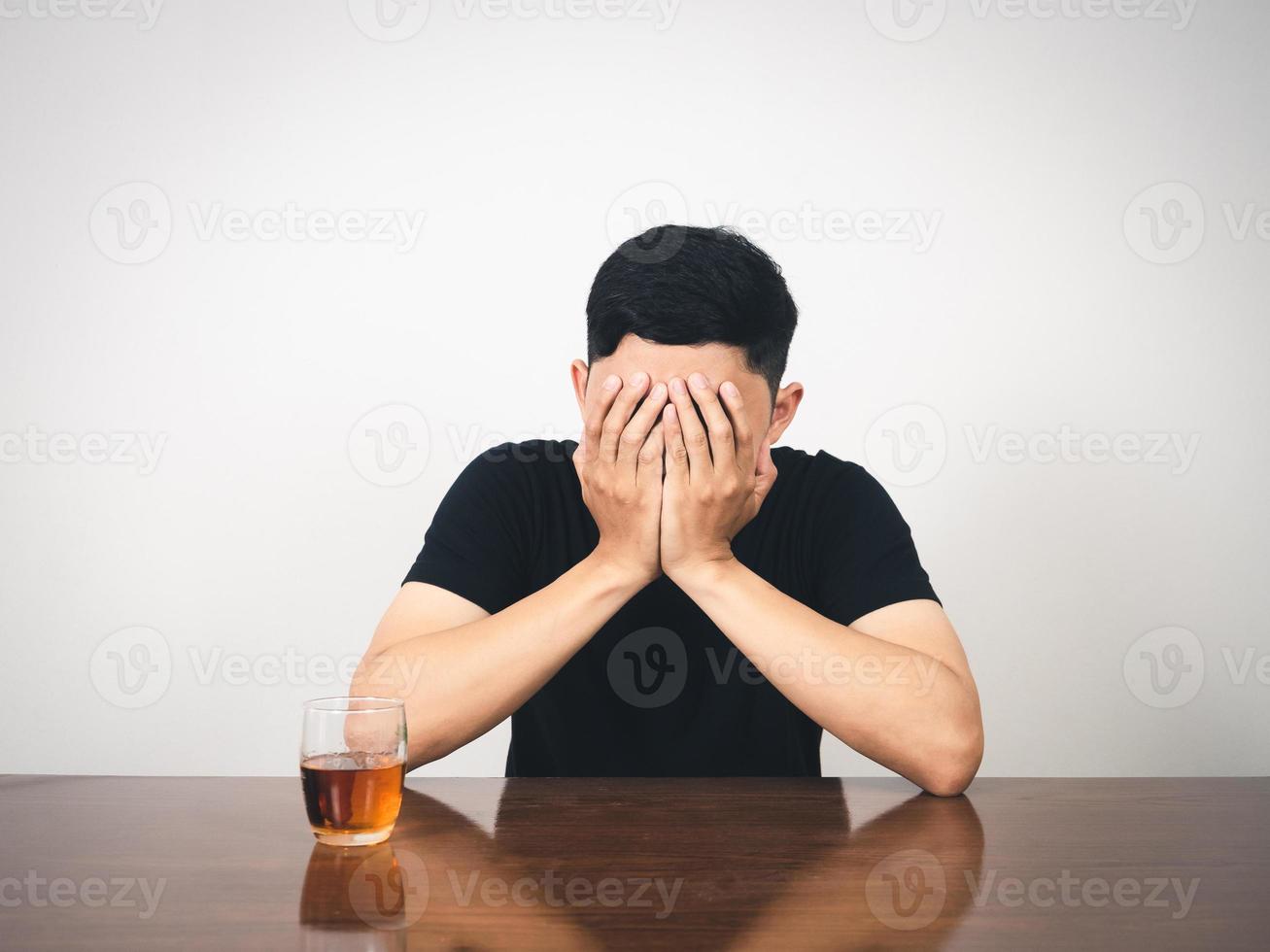 Man alcoholism hangover sitting and close his face feels lonely photo