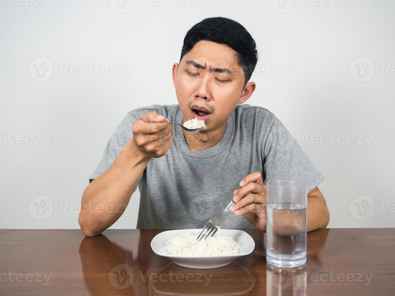 Sadness man eatting rice on table photo