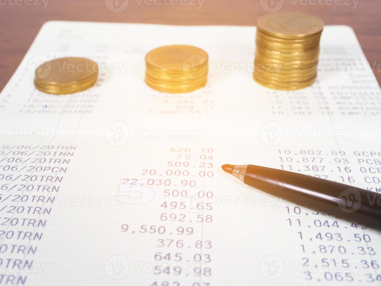 Closeup account statement banking with coin on table photo