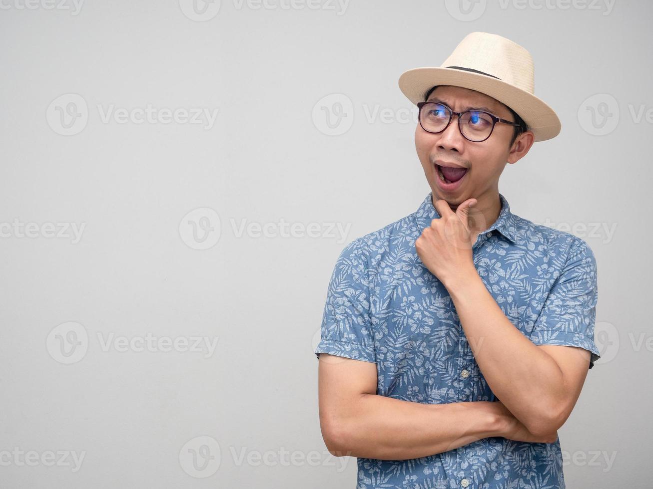 Tourism man wear hat gesture thoughtful and looking at copy space photo