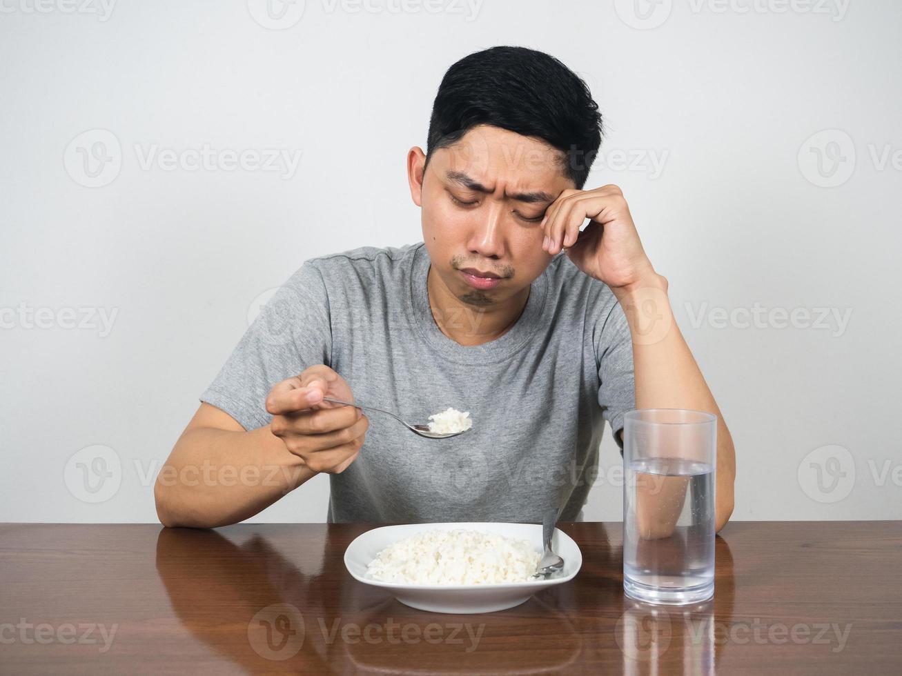 Depressed man feels bored food crying don't want to eatting rice on the table photo