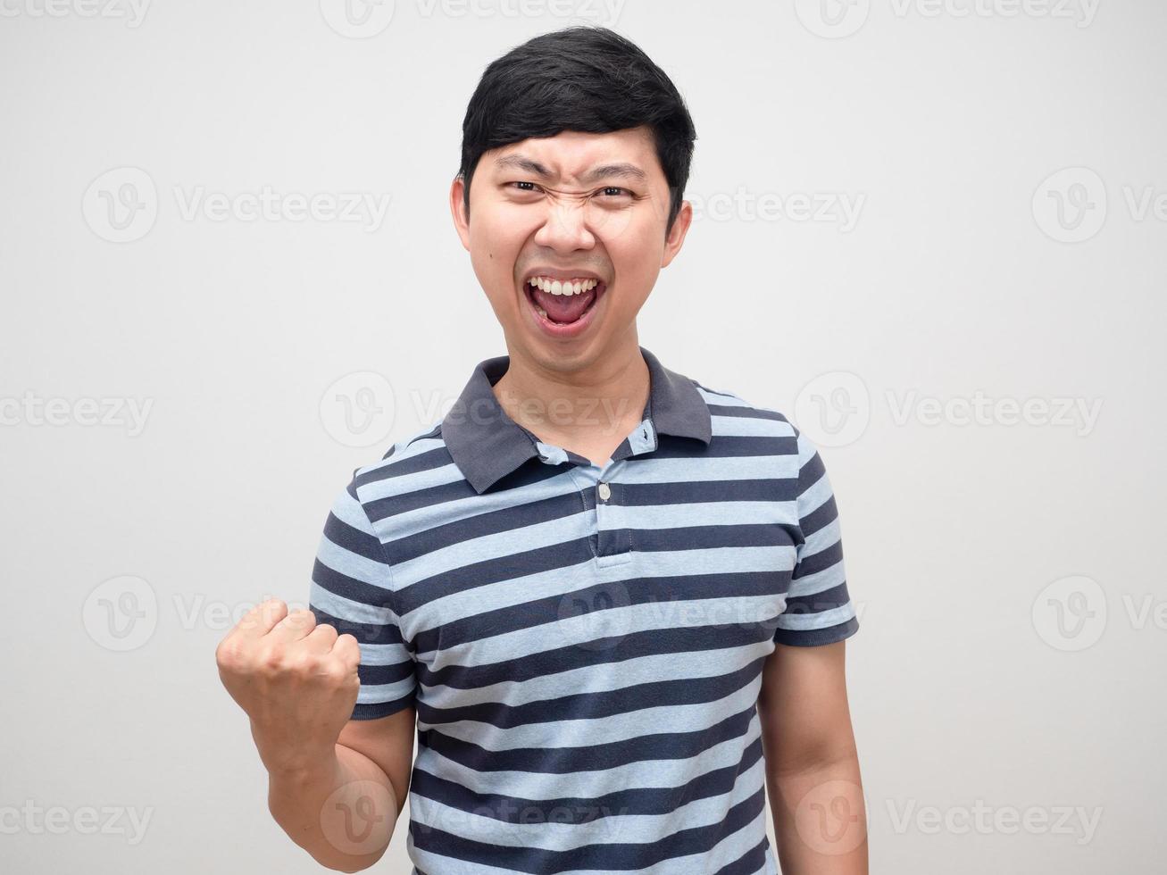 Asian man blue shirt gesture satisfy happy emotion and fist up photo
