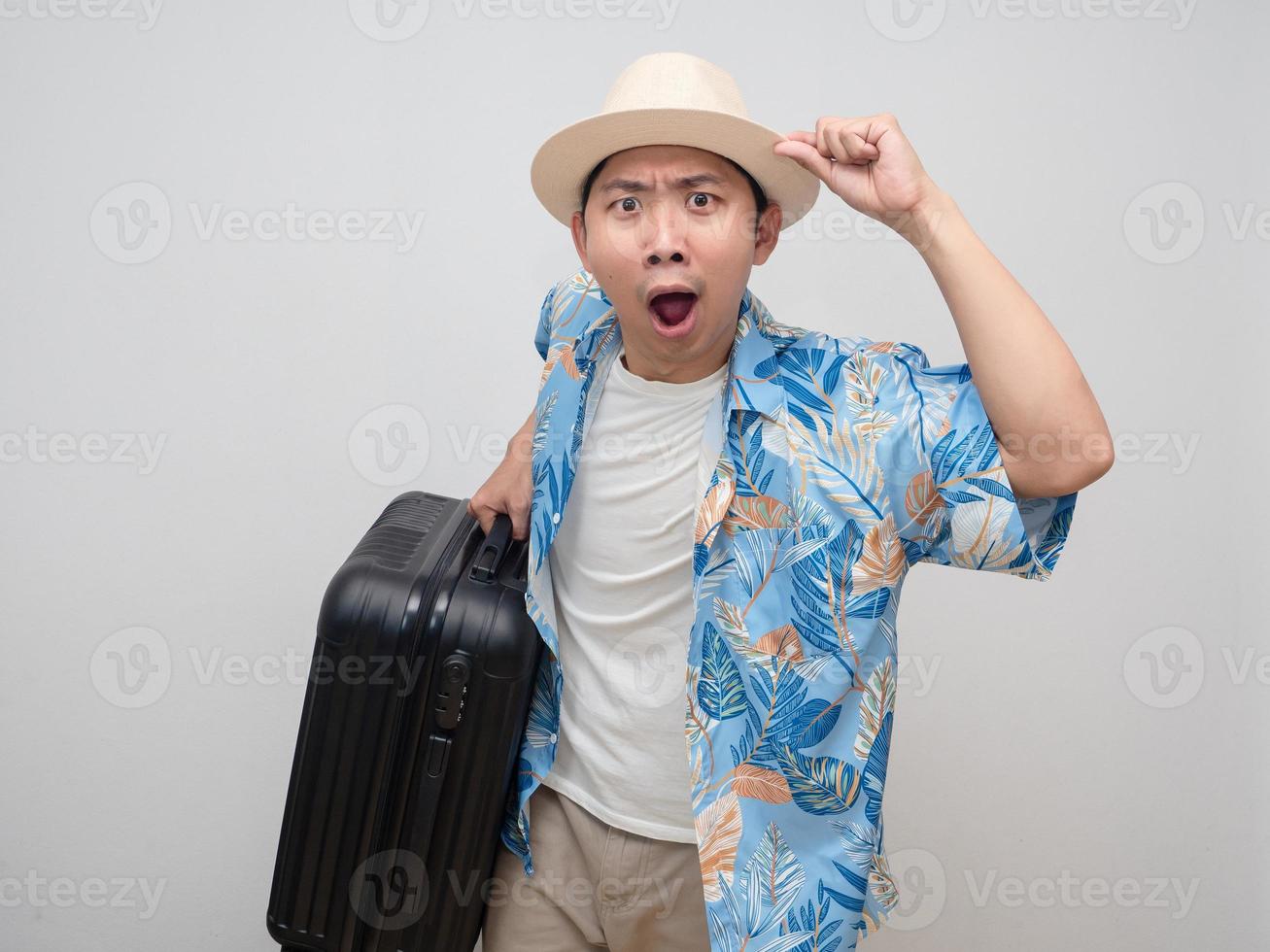 Tourism man wear hat carry luggage gesture amazed with holiday photo