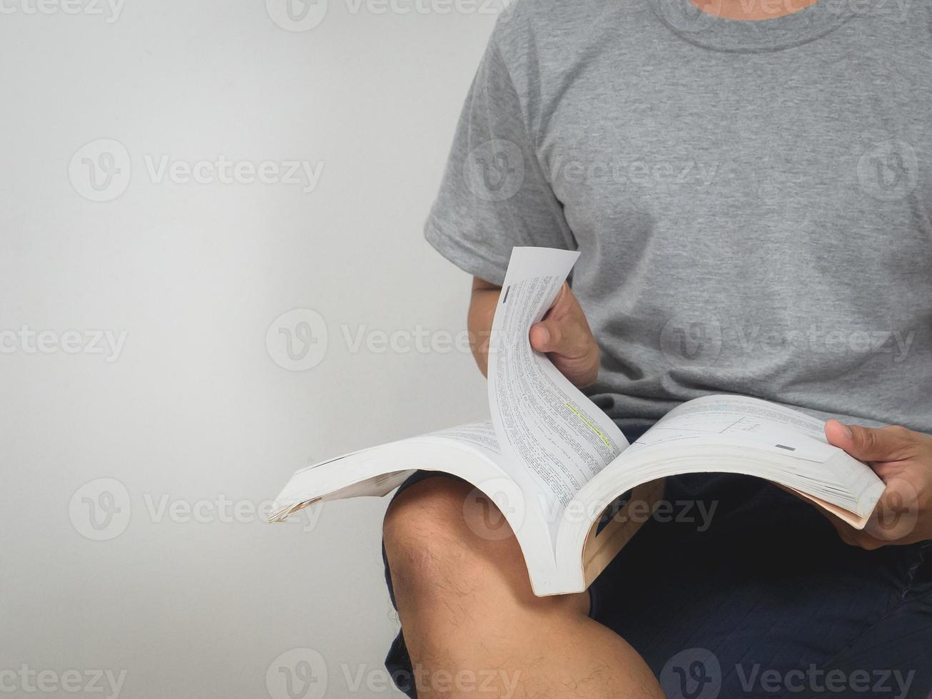 Close up man sit reading text book white background photo