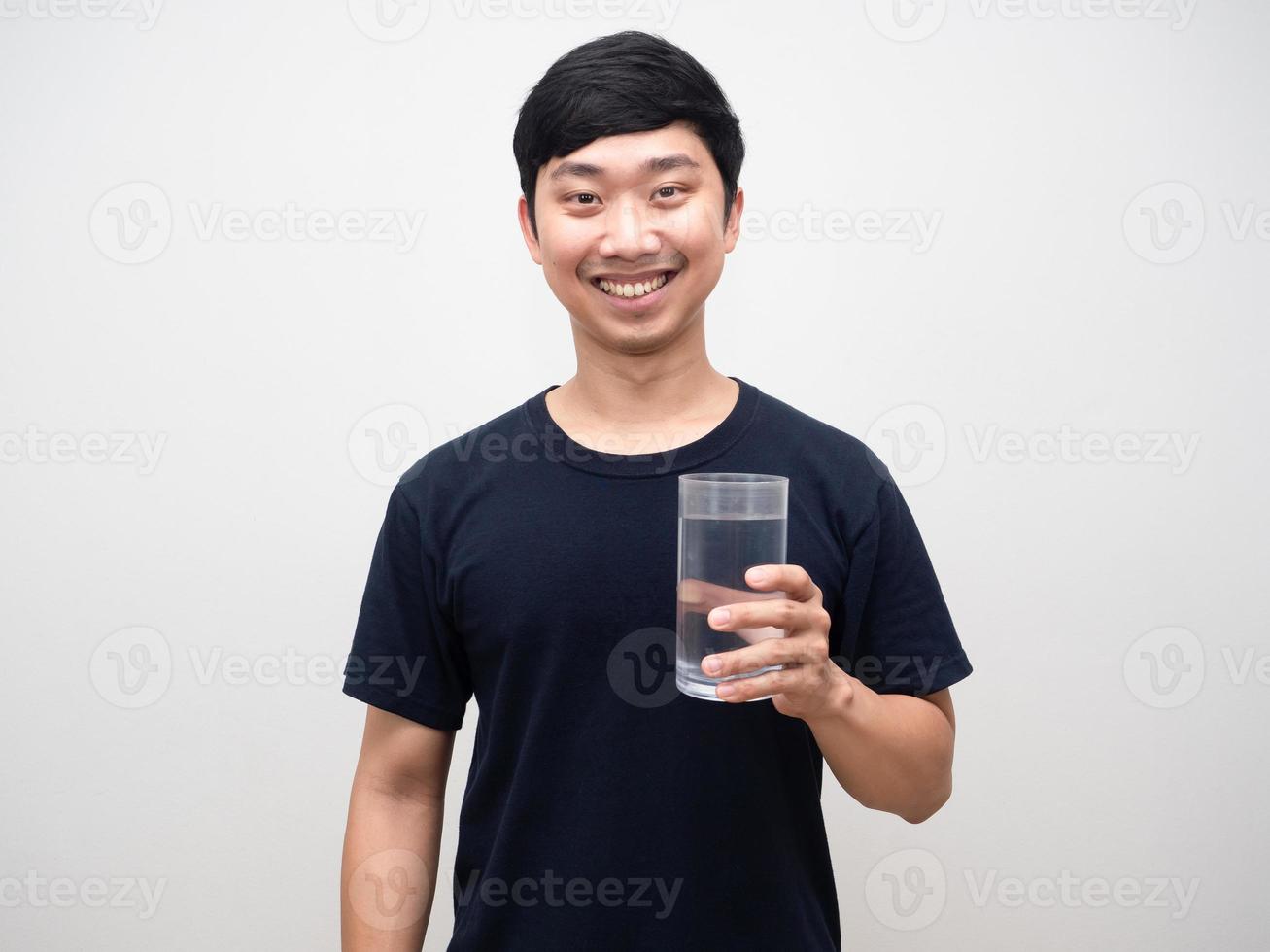 Portrait positive man holding glass of water gentle smile white background photo