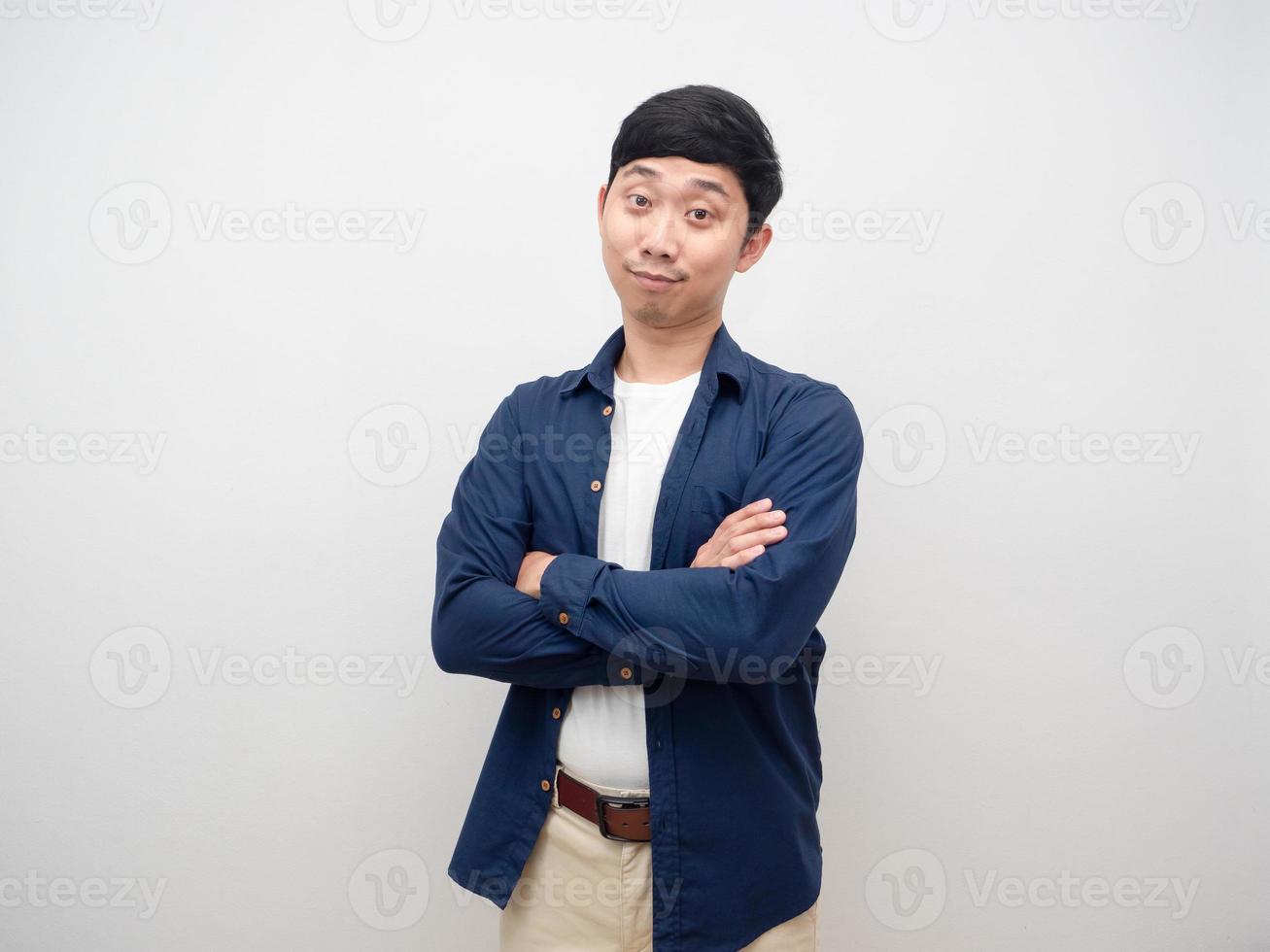 Positive young man standing cross arm smile studio shot isolated photo