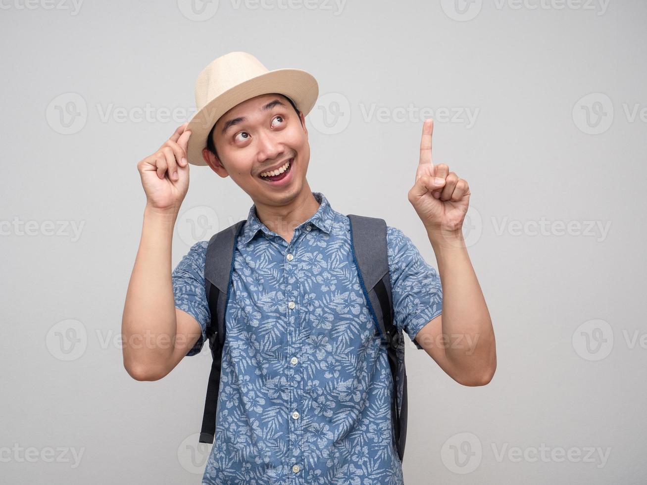 Traveler man with backpack gesture point finger up isolated photo