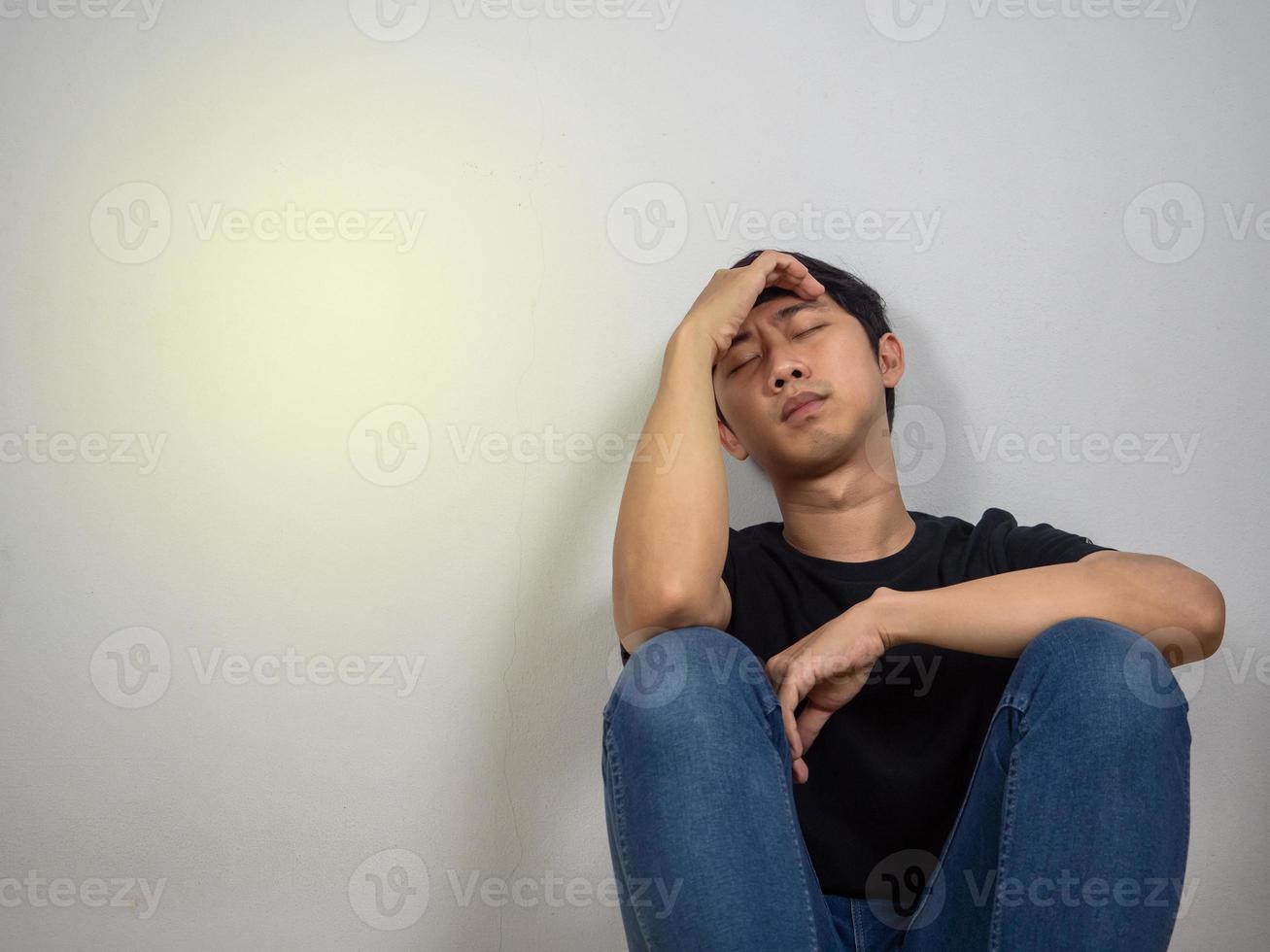 Depressed man feels strain sit on floor copy space isolated photo