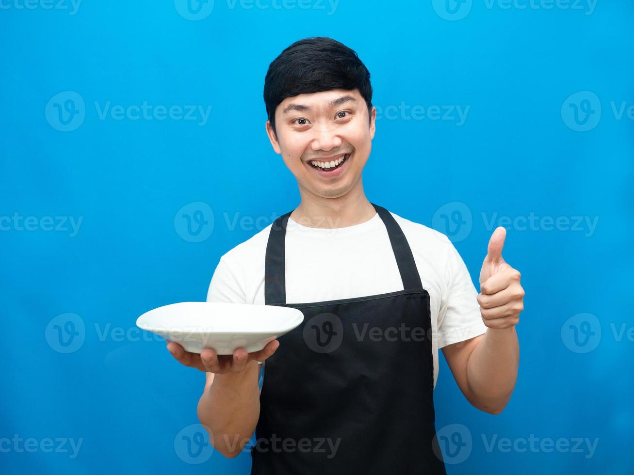 Chef man showing empty dish happiness smile thumb up blue background photo