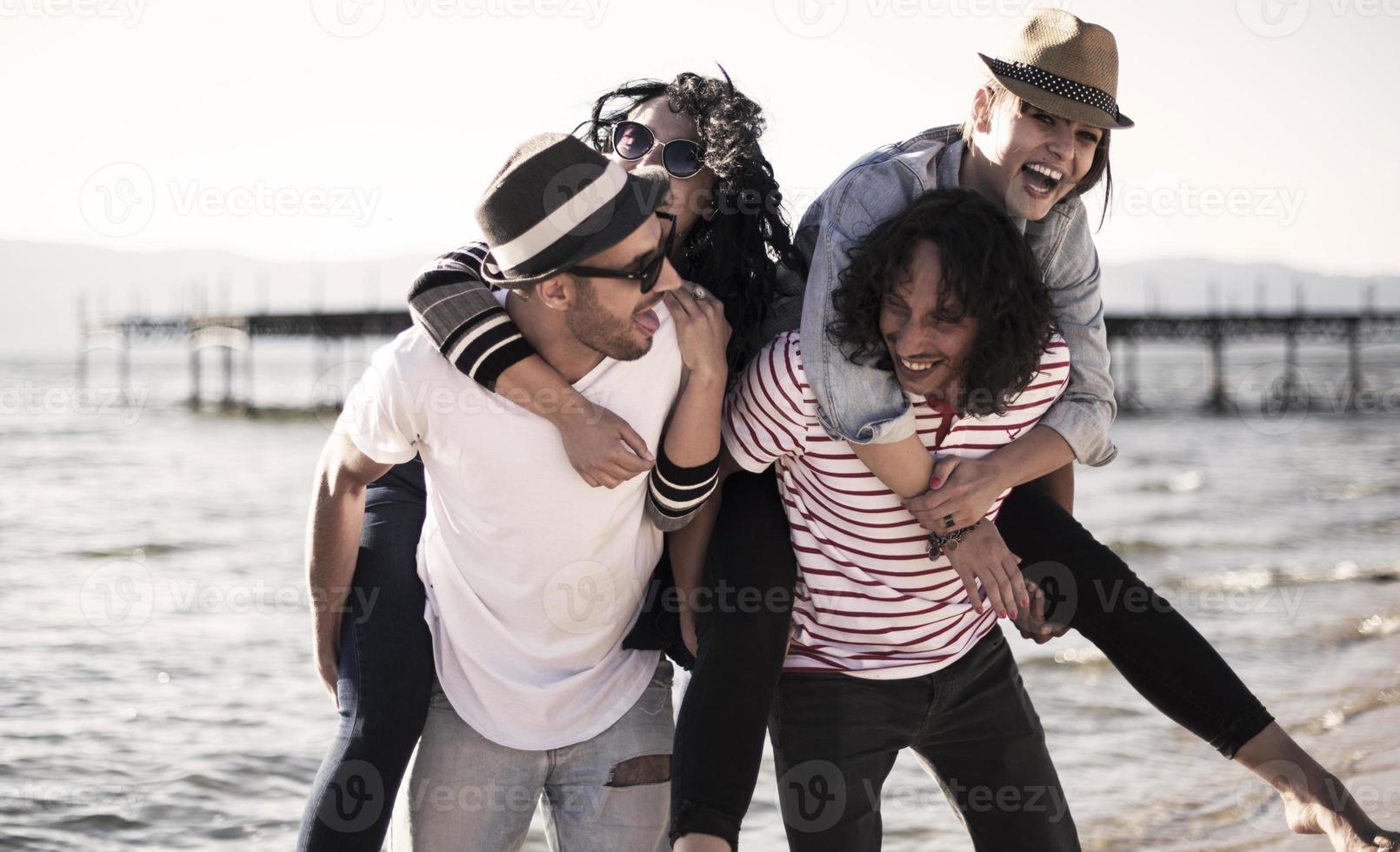 Young people having fun by a lake. Young friends relaxing by a lake. photo