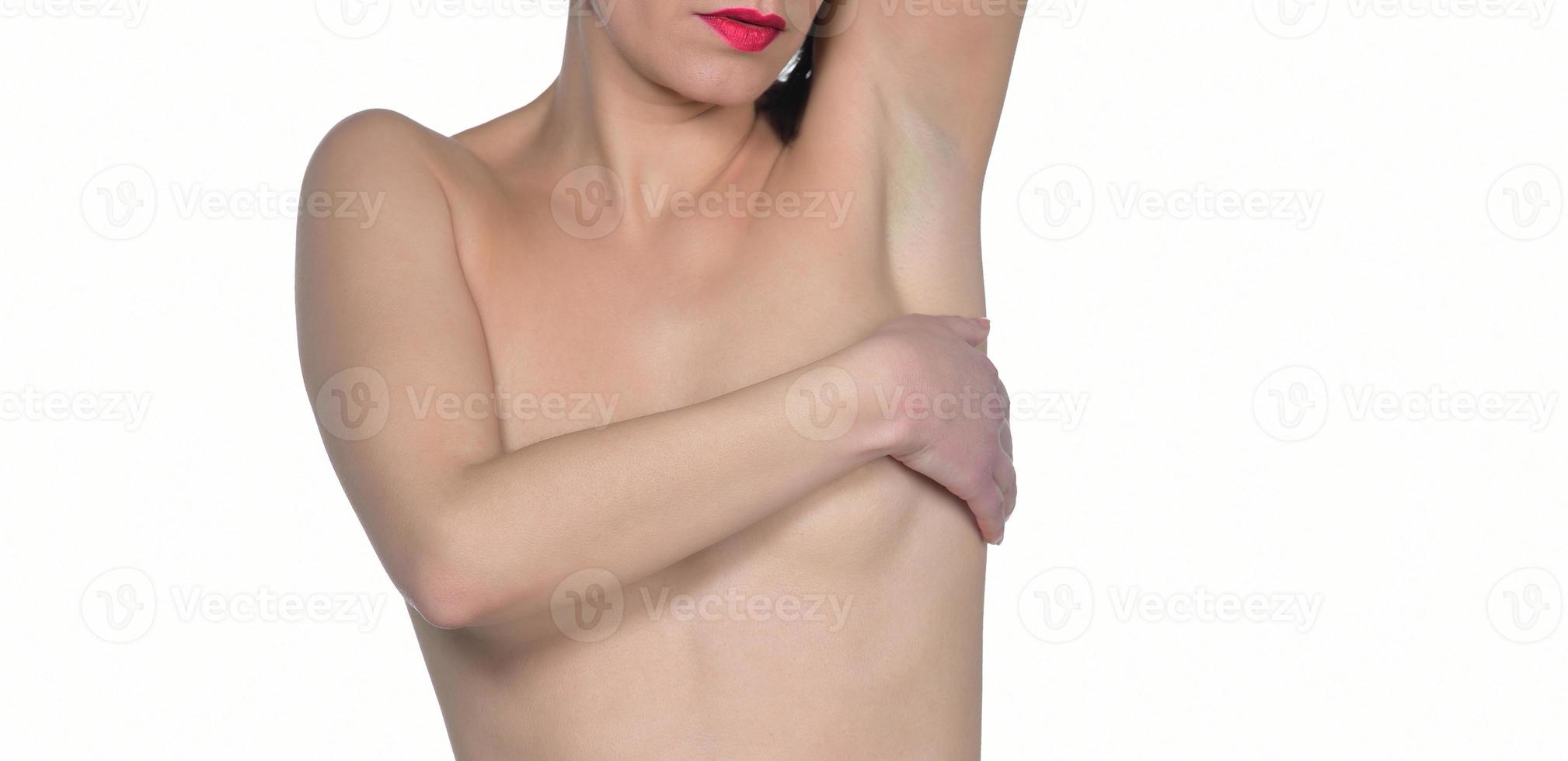 woman covering her breast. Breast cancer concept. Beautiful woman covering her nude breast isolated on white background photo