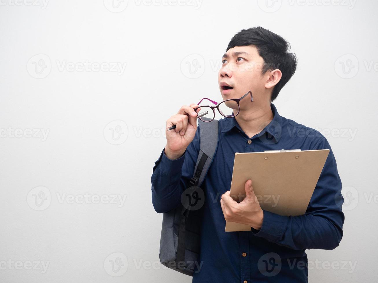 Businessman holding document board with bag take off glasses looking at copy space feel amazed photo