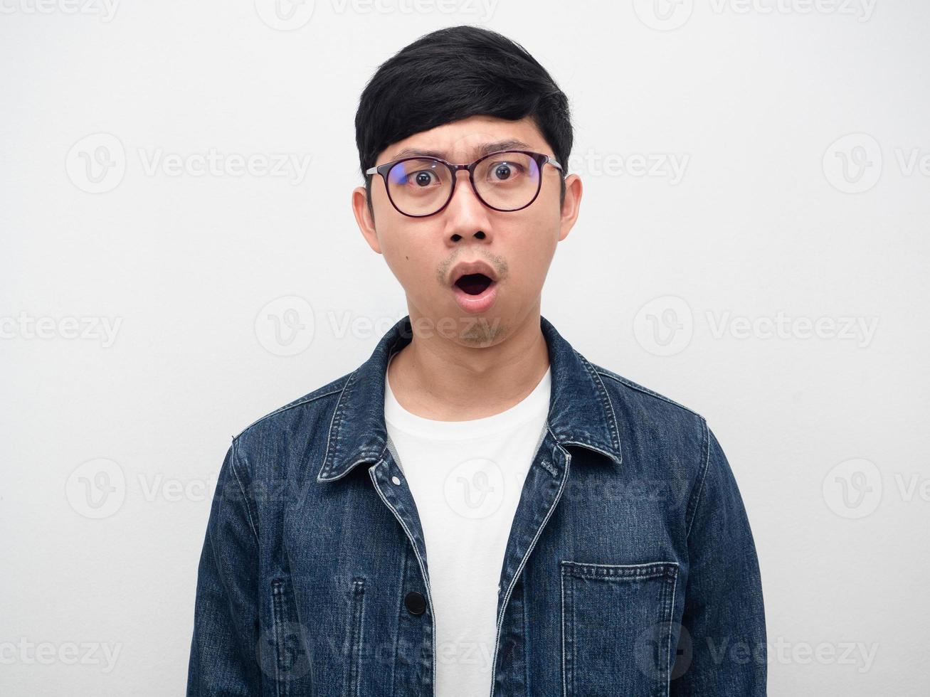 Asian man wearing glasses shocked face studio shot,Man jeans shirt photo