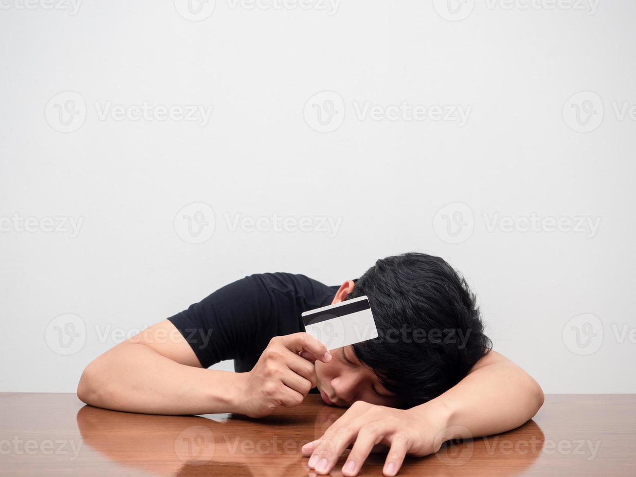 Man tried from working laying head down hold credit card strain with crisis and debt photo