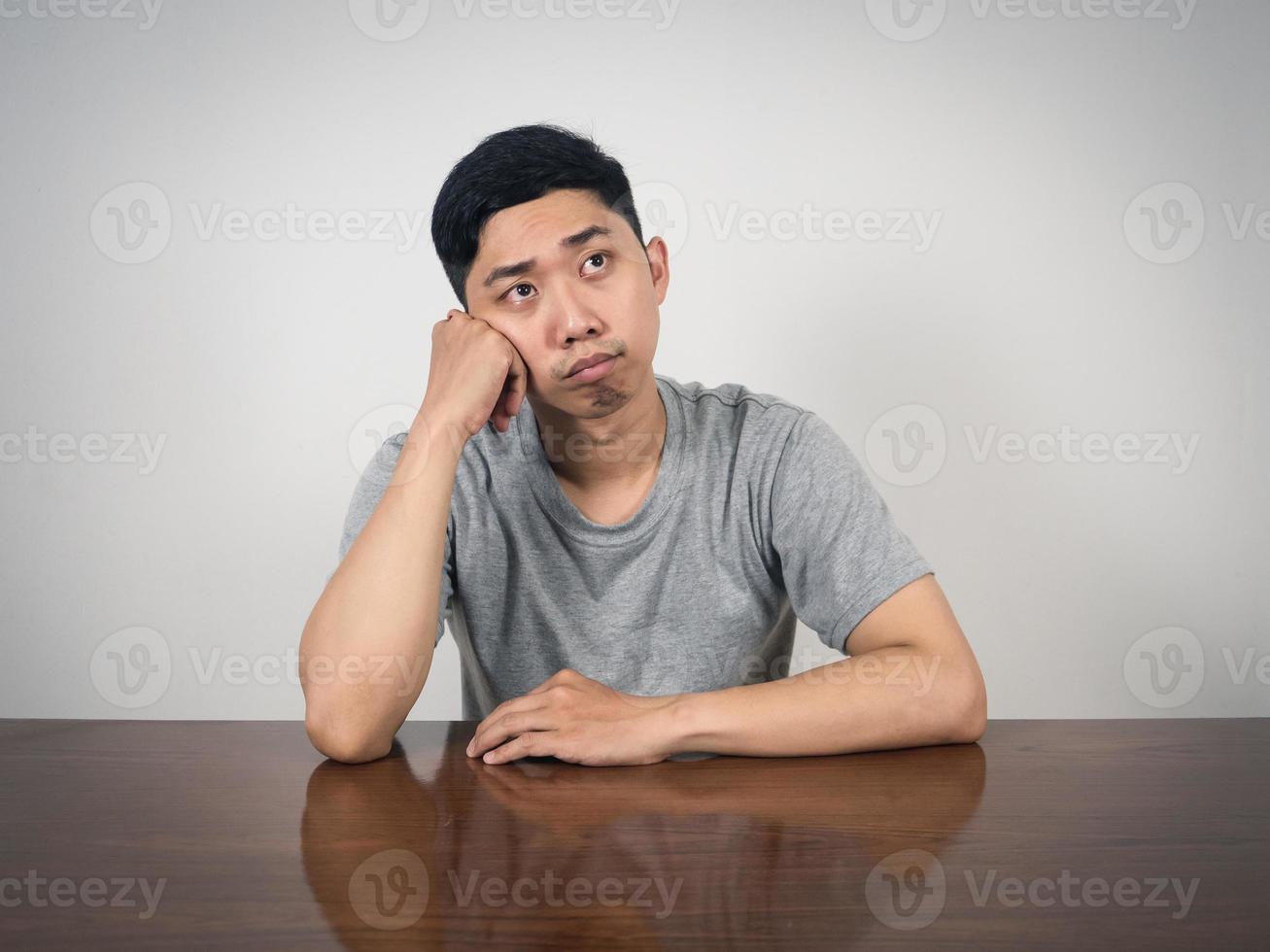 Depressed man sit at table thoughtful something photo