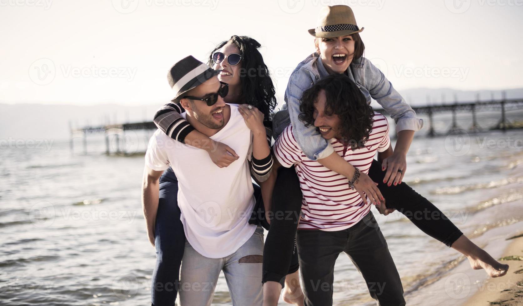 Young people having fun by a lake. Young friends relaxing by a lake. photo