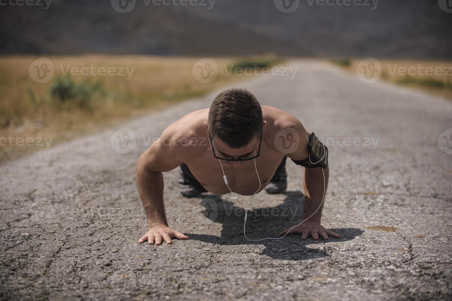 Young man runner running on a mountain road. Jogger training workout in fitness shoe. Healthy lifestyle and sport concept.  Motion blur and selective focus. photo