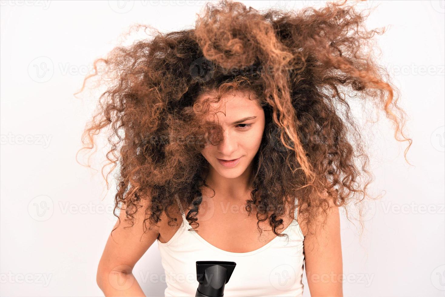 nice-looking attractive well-groomed cheerful cheery wavy-haired girl using electric dryer photo