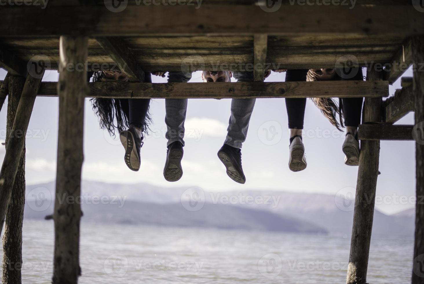 Group of young people at a lake on a sunny day photo