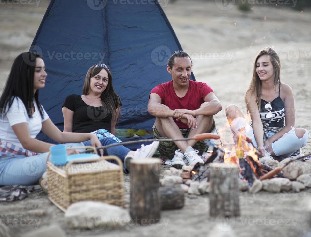 summer, holidays, vacation, music, happy people concept - group of friends with guitar having fun on the beach photo