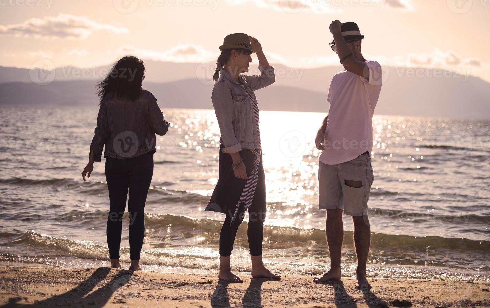 Young people having fun by a lake. Young friends relaxing by a lake. photo