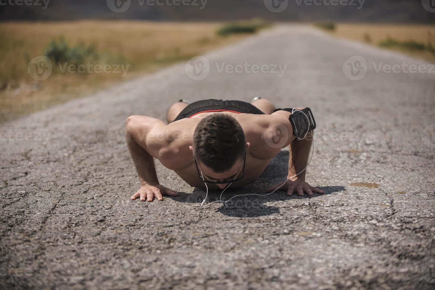 Young man runner running on a mountain road. Jogger training workout in fitness shoe. Healthy lifestyle and sport concept.  Motion blur and selective focus. photo