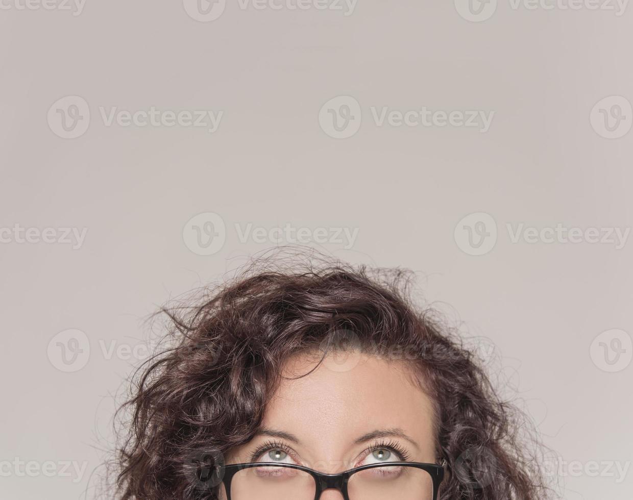 half portrait of a young girl with glasses looking up photo