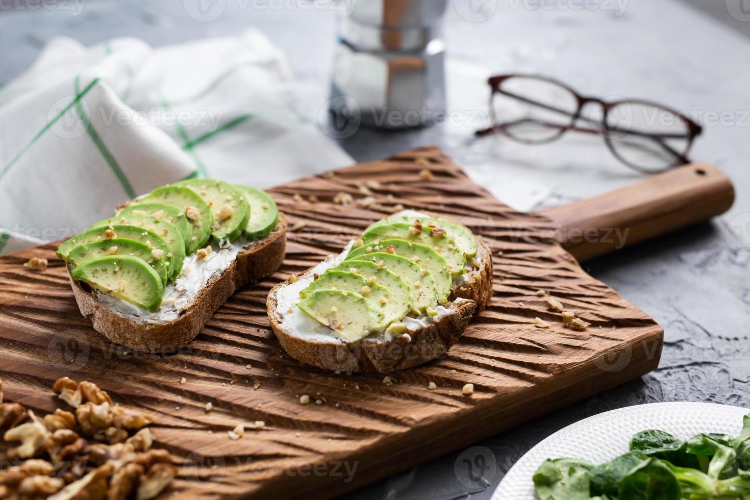 sliced avocado on toast bread with nuts photo