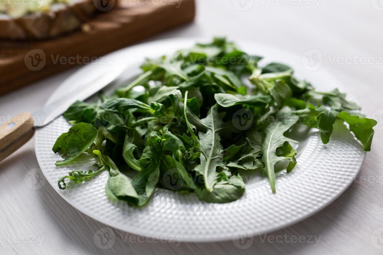 Fresh arugula salad on a plate. Concept of dieting or detox or vegetarian photo