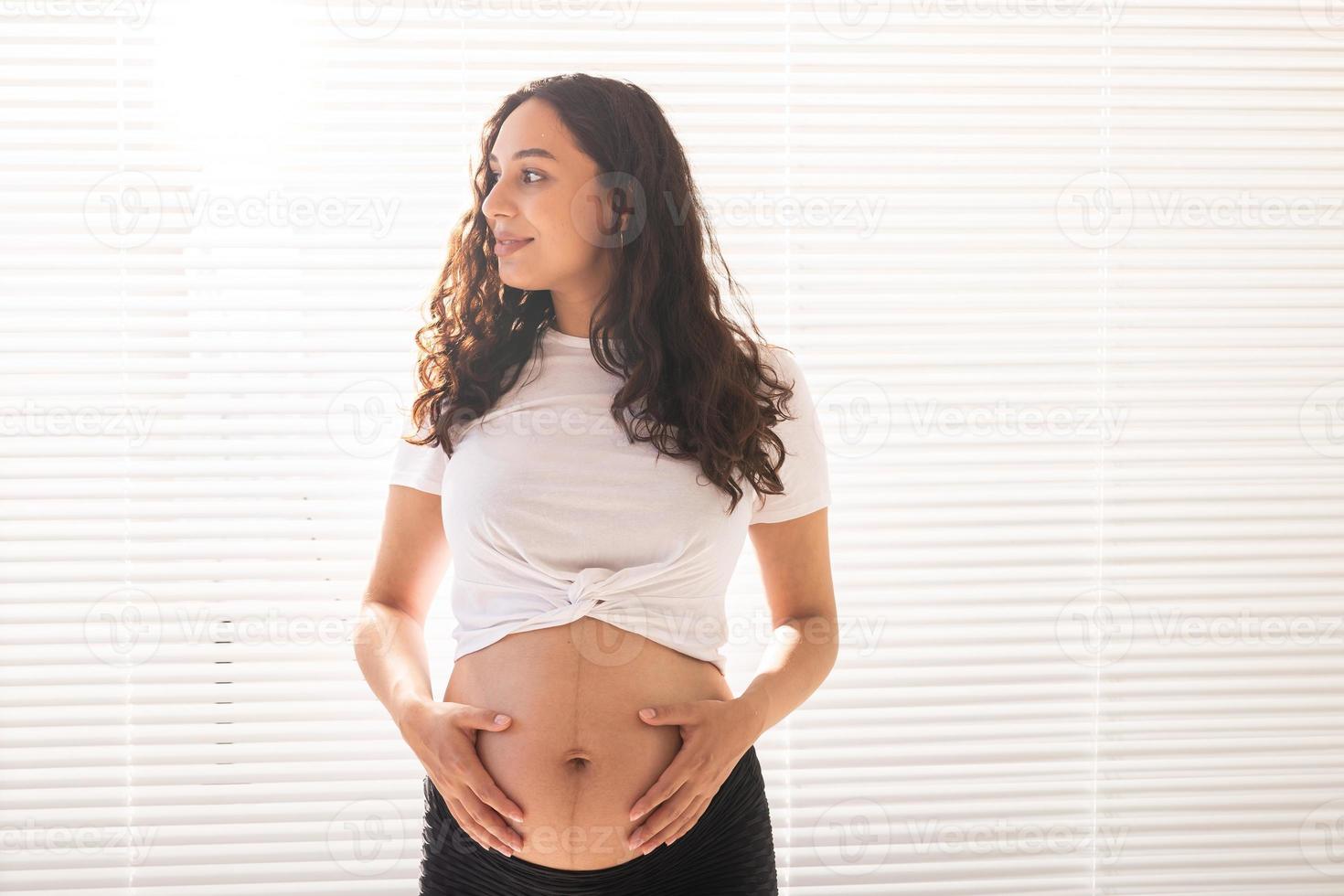 Pregnant woman touching her belly, copy space. Pregnancy and maternity leave photo