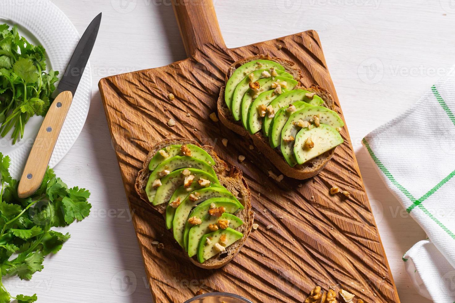 Avocado toasts for breakfast or lunch with rye bread, pumpkin seeds. Vegetarian food top view photo