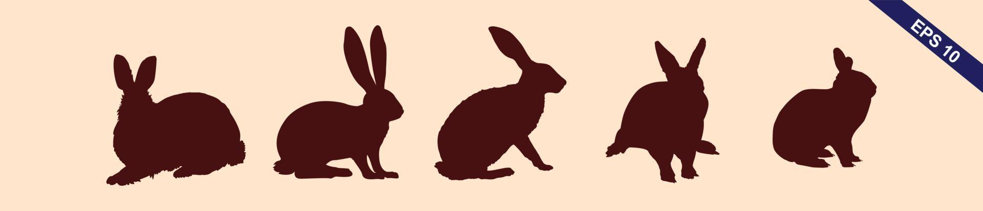 siluetas de conejitos de pascua aislados en un fondo marrón claro. conjunto de diferentes siluetas de conejos para uso de diseño. vector