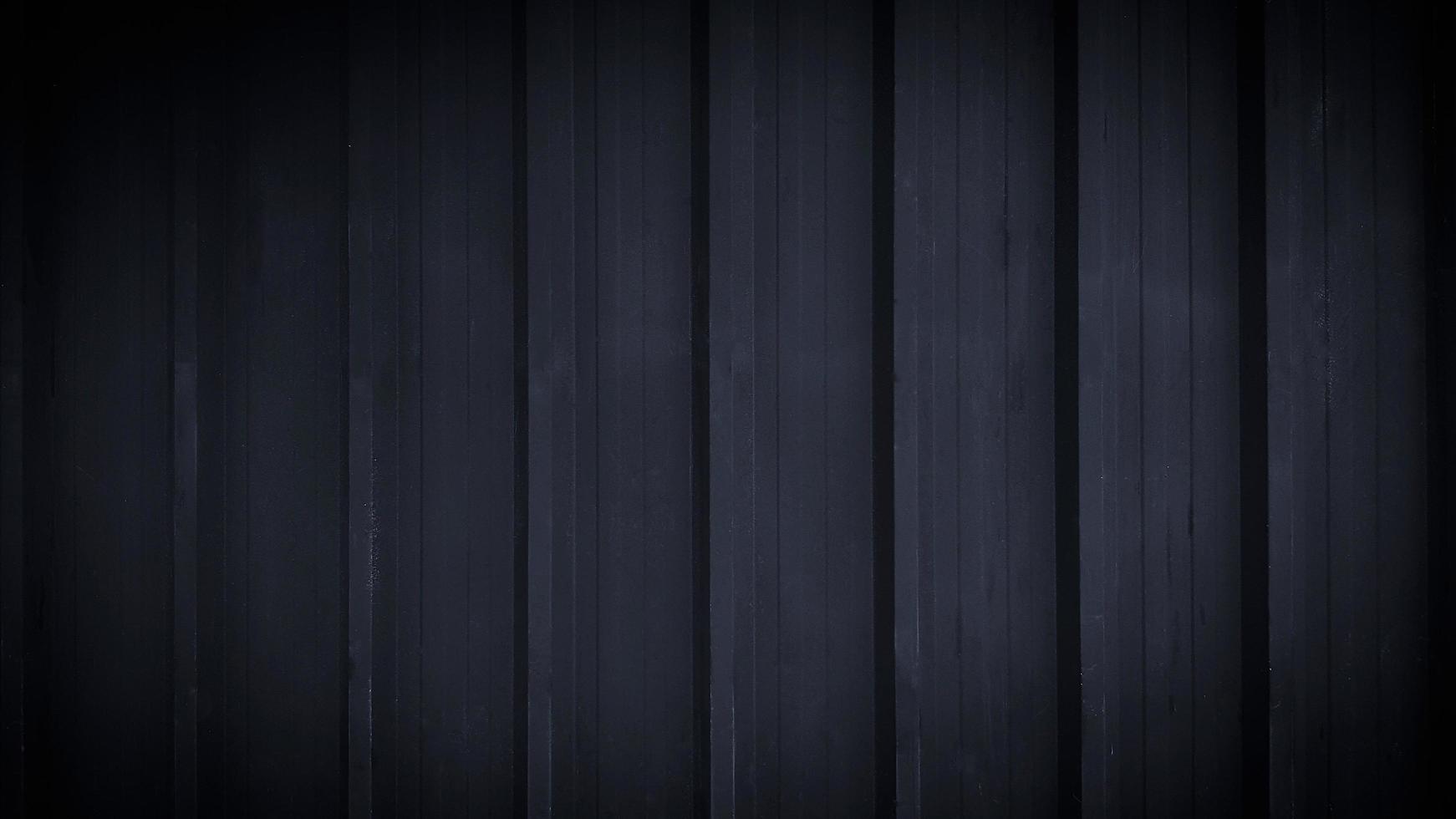 Black stainless steel background in vintage tone. Dark shutter door wall with copy space. Line pattern of curtain or zinc wallpaper concept. photo