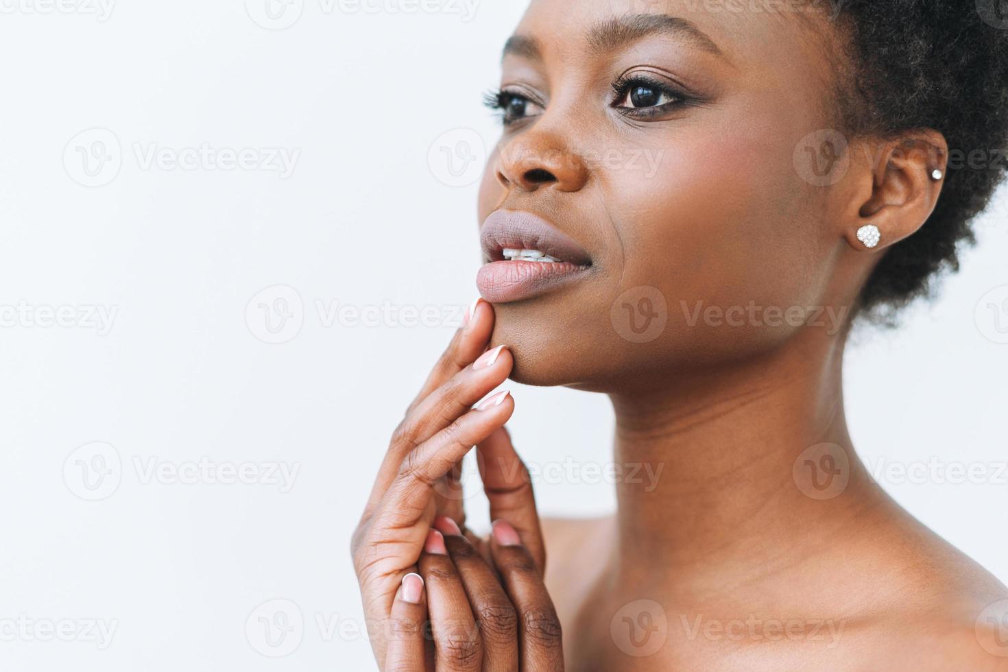 Beauty portrait of beautiful young African American woman hands near face isolated on the white background photo