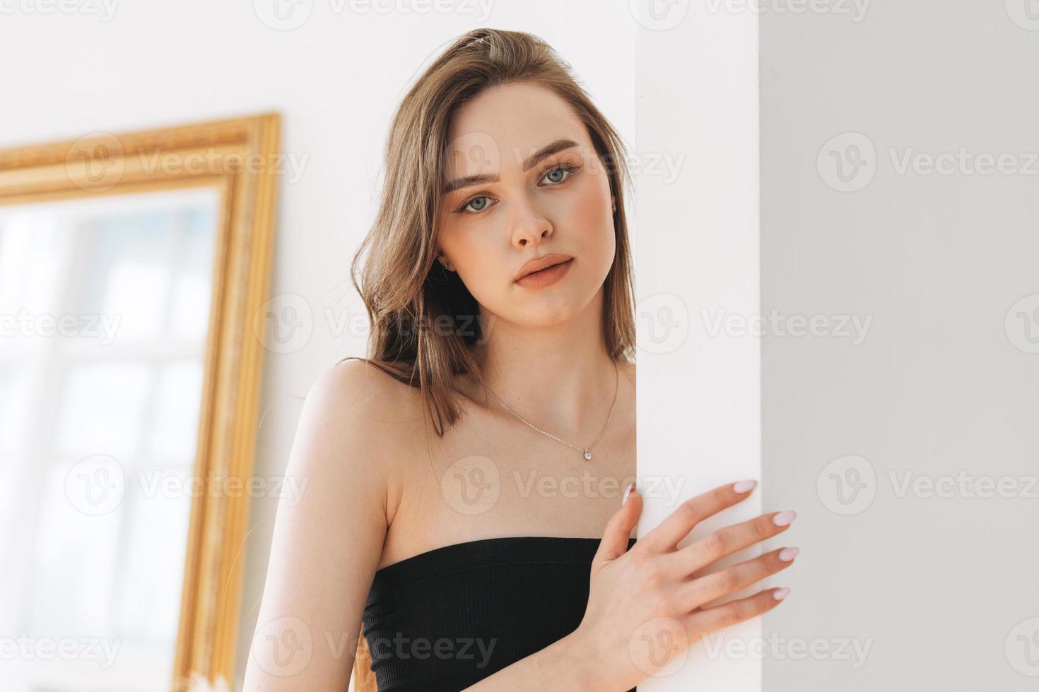 Hermosa mujer joven modelo de moda de belleza con cabello largo en ropa interior deportiva sin costuras mirando a la cámara en el estudio brillante foto