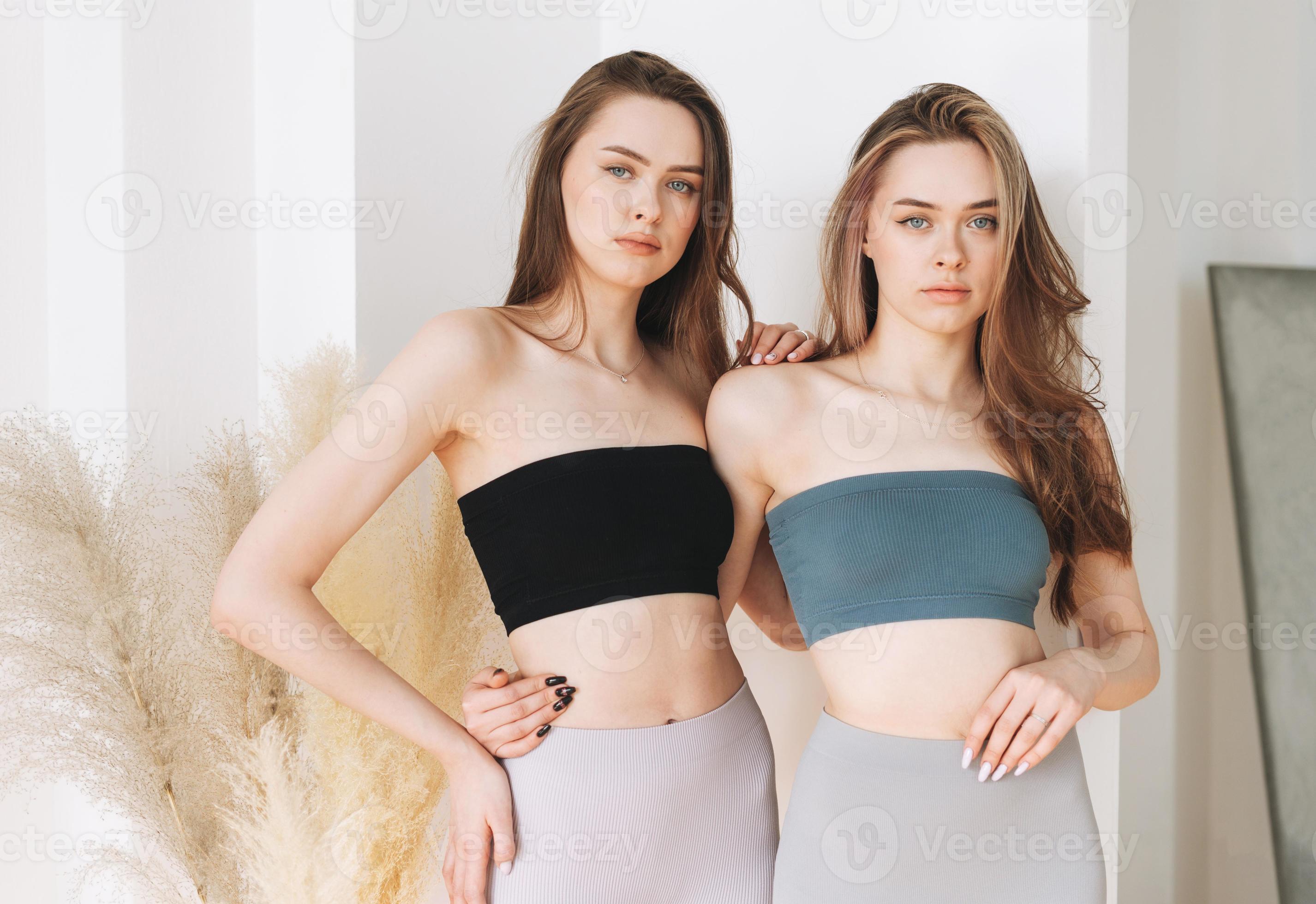 Fashion beauty models two sisters twins beautiful girls with long hair in  sport seamless ribbed underwear in bright studio 16799786 Stock Photo at  Vecteezy
