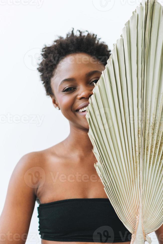 Beautiful smiling afro american young woman beauty fashion model looking at  camera with dry leaf on white background, eco concept nature beauty  16800088 Stock Photo at Vecteezy